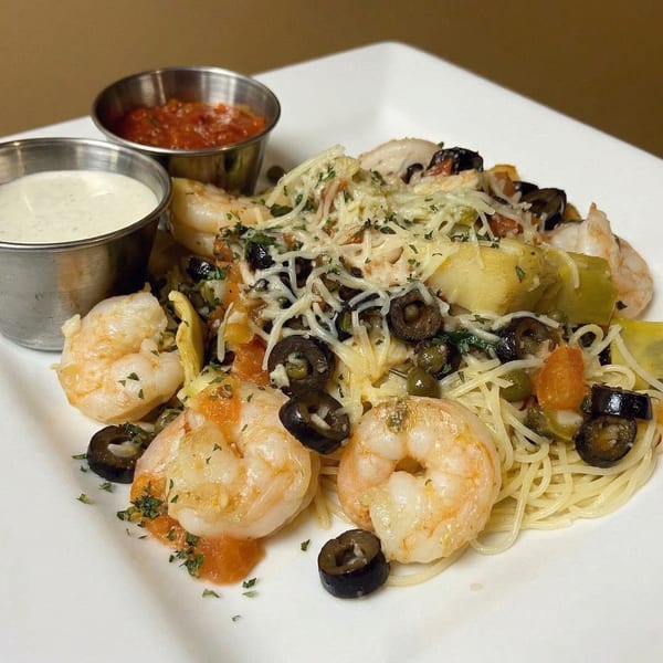 Shrimp scampi with angel hair pasta, olives, artichoke hearts, and two dipping sauces.